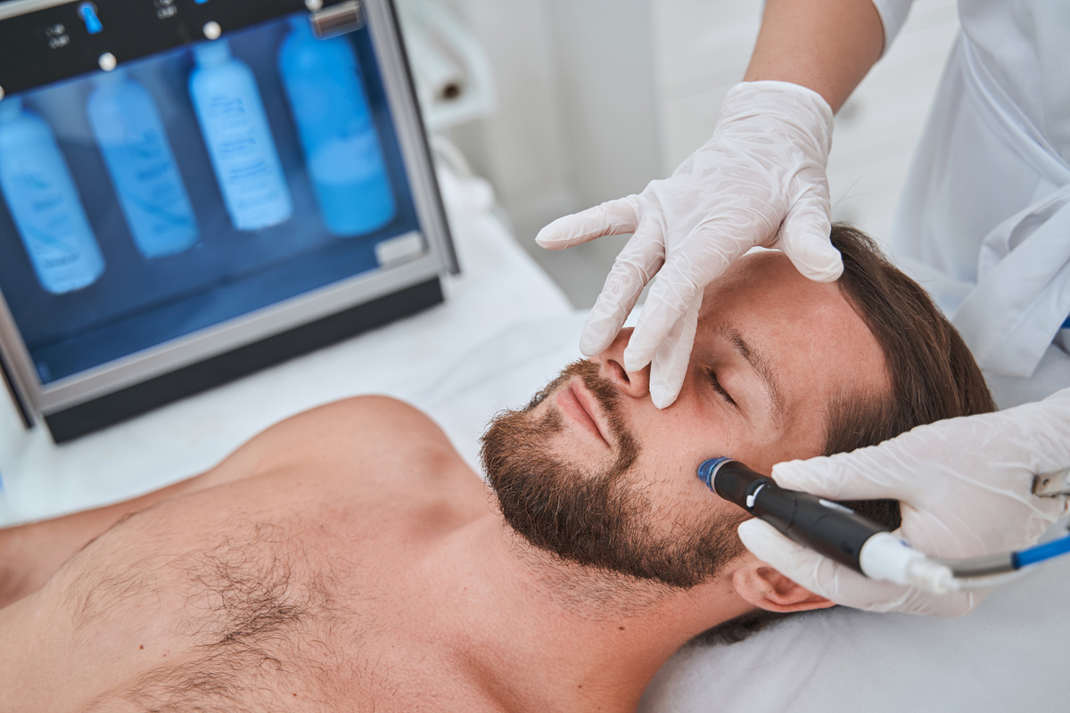 Man undergoing a facial skin cleansing procedure